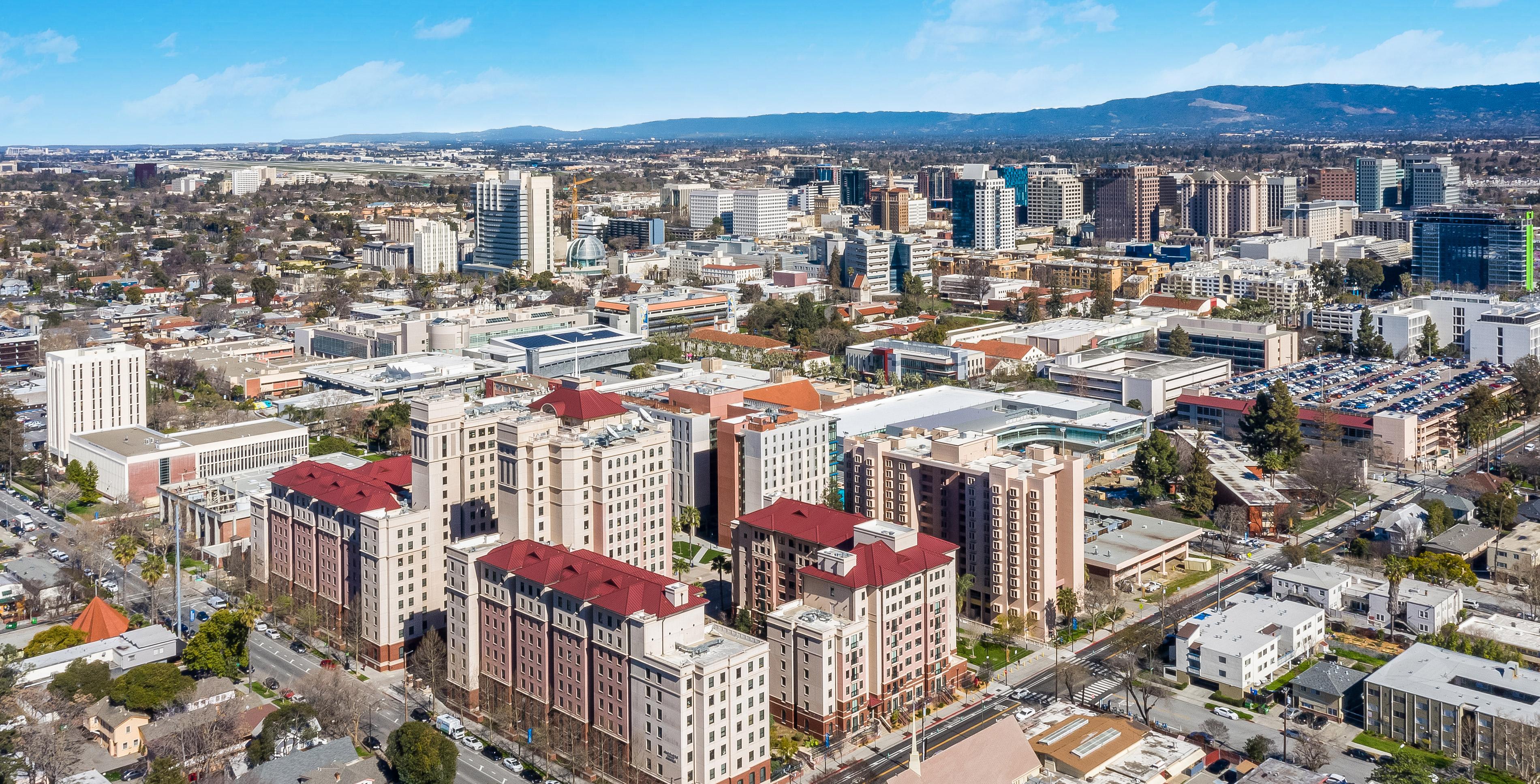 Arial shot of the 菠菜网lol正规平台 Campus from above the Campus Village, looking outwards to downtown San Jose. 